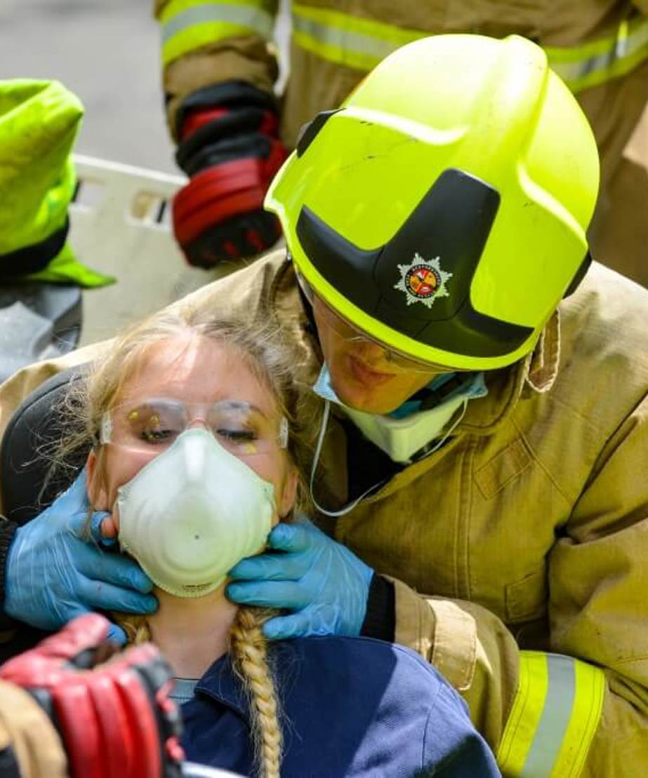 Trainee firefighter applying breathing mask