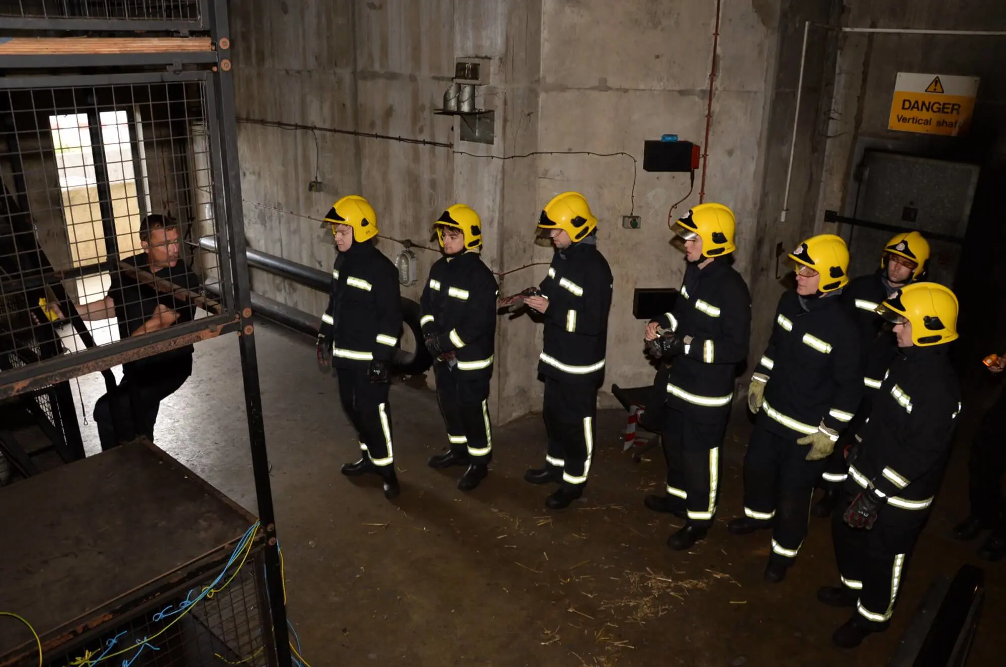 Trainee firefighters watching instructor 