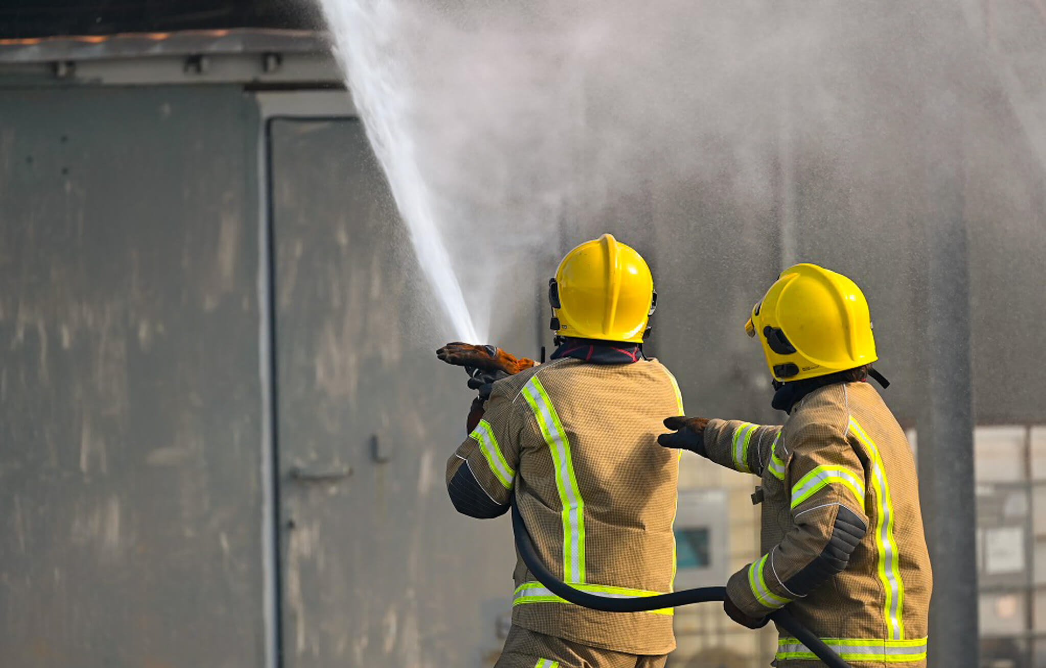 Firefighter trainees with fire hose