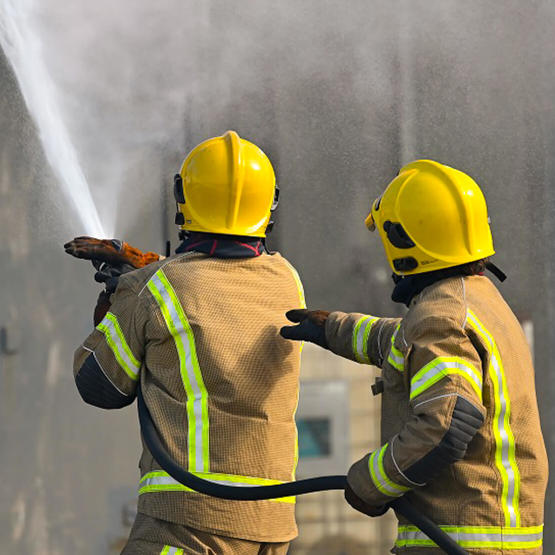 Firefighter trainees with fire hose