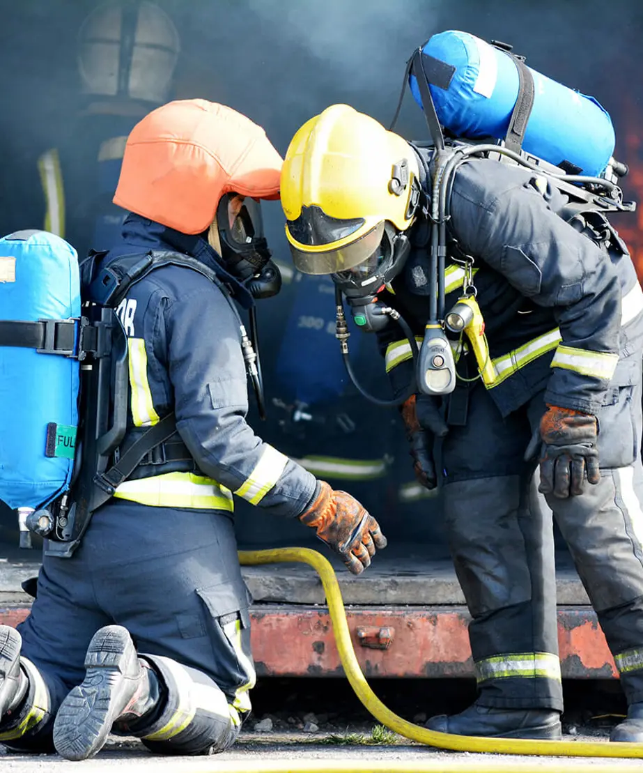 Trainee firefighters with oxygen tanks